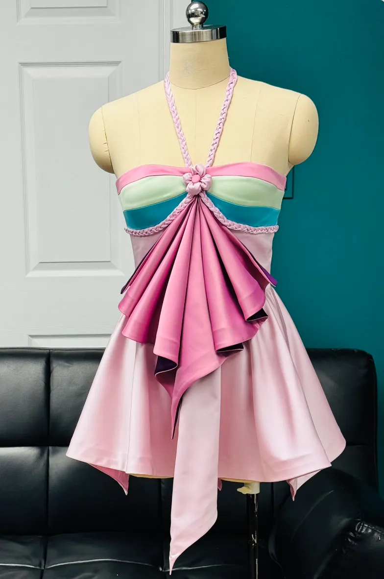 Finished custom pink halter top with draped satin ruffle on a dress form