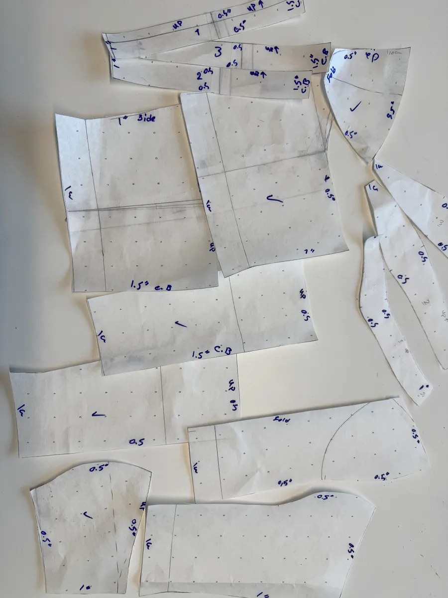 Paper sewing pattern pieces drafted for a custom garment